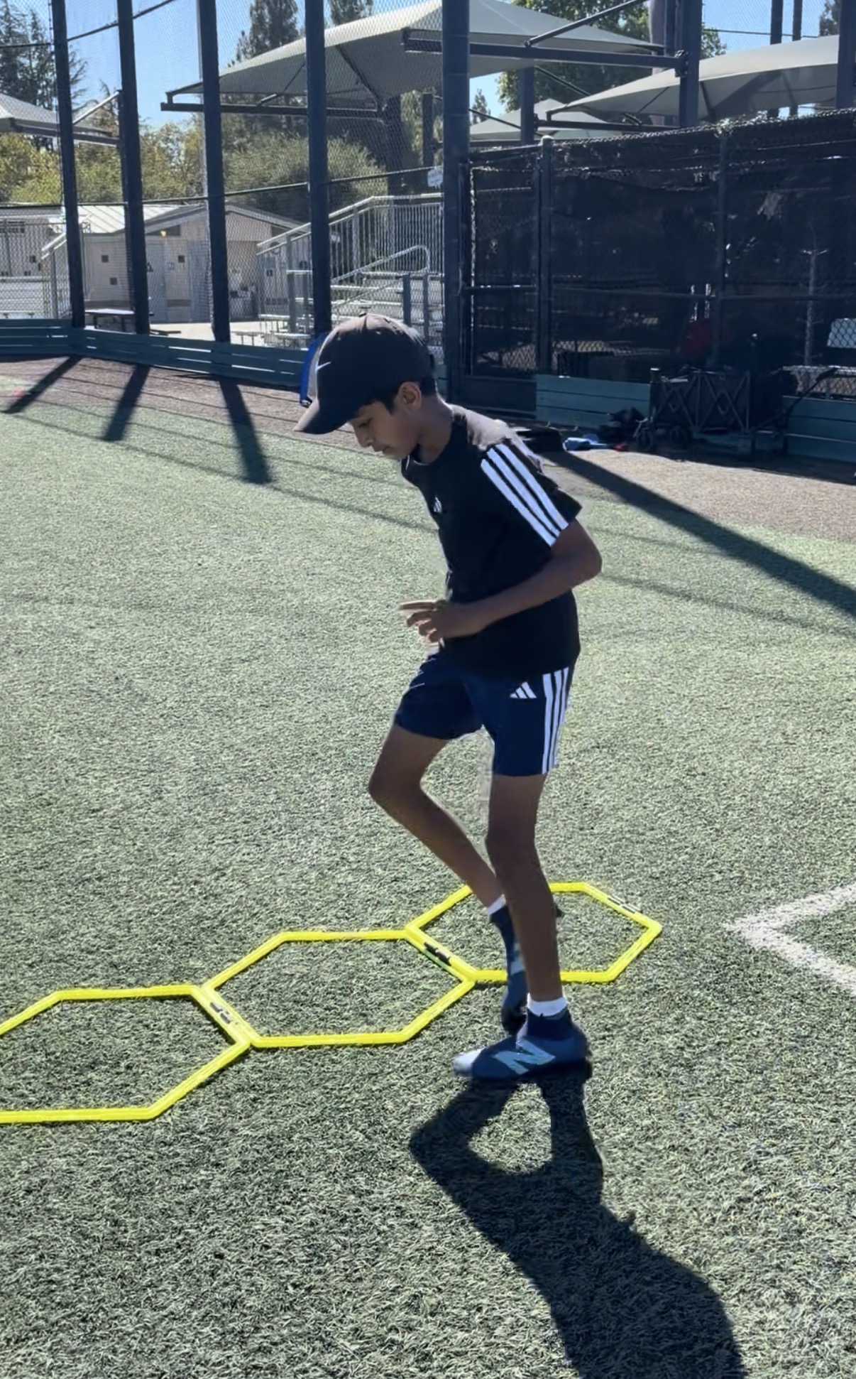 Player working through a hex agility ladder during a footwork drill